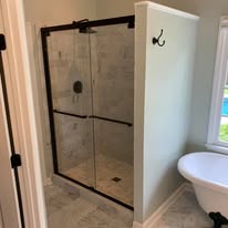 Glass-door walk-in shower with clawfoot tub bathroom remodel